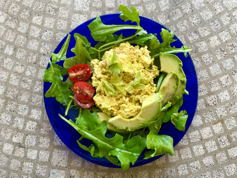 Vegan eggless creamy tofu salad salad on a plate with greens
