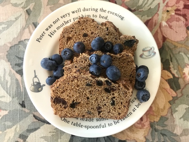 slices of granny cake topped with fresh blueberries on a plate