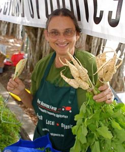 Margie Pikarsky of Bee Heaven Farms stands with vegetable