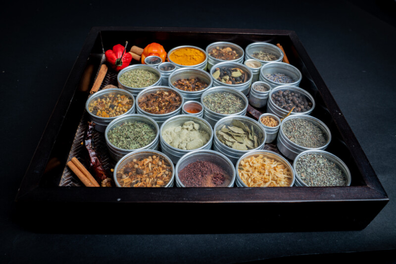 A tray filled with tins of herbs and spices. 